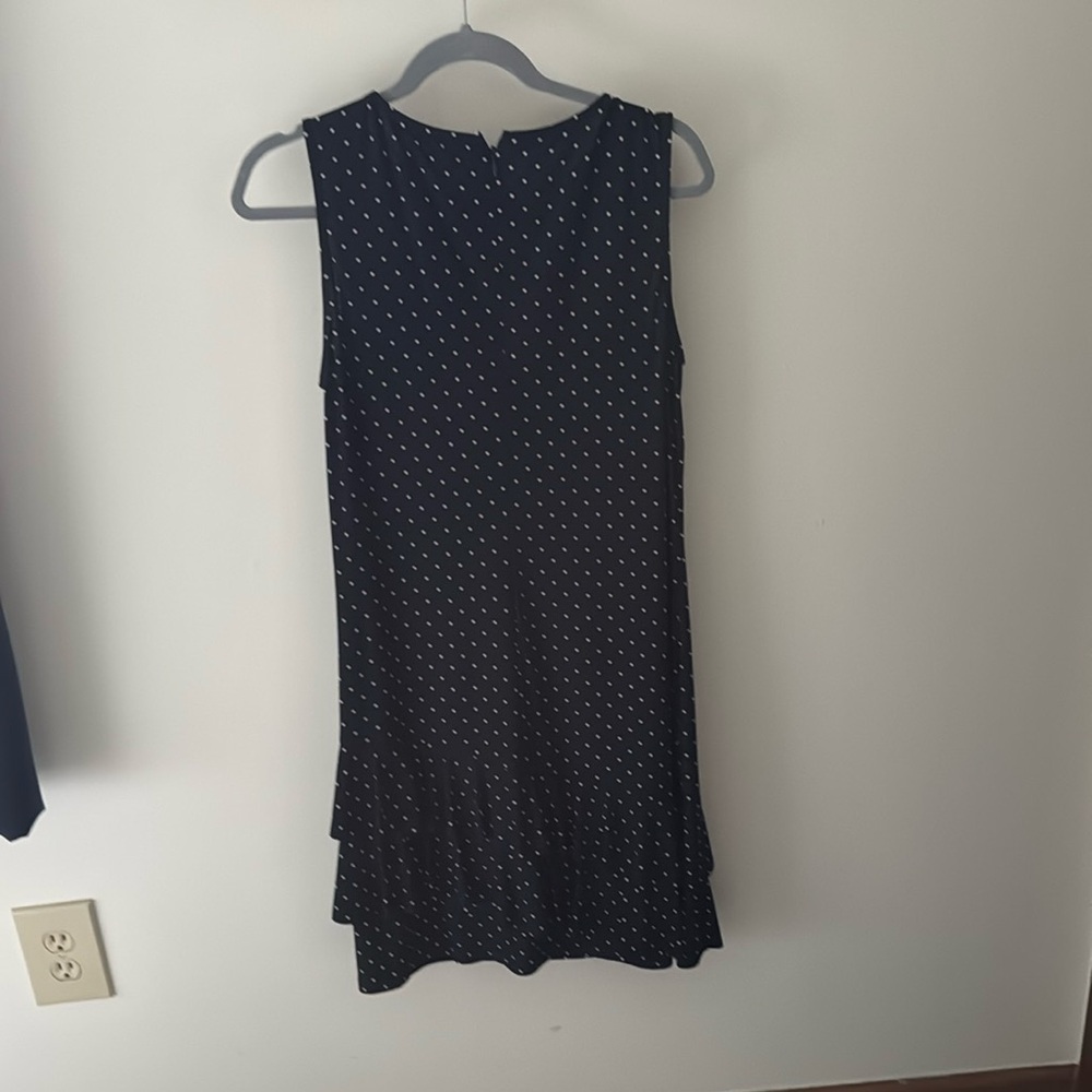 American living navy polka dot dress with ruffles at hem.